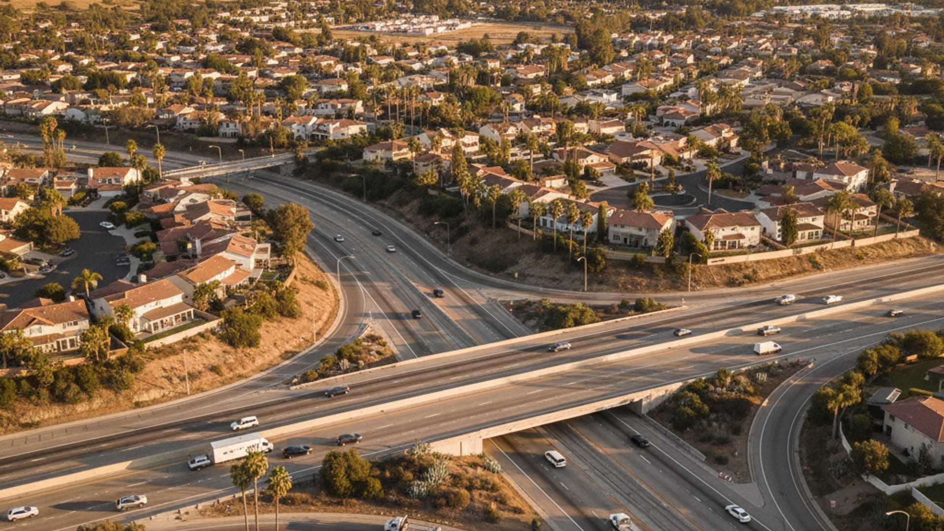 Elevated drone view of the Springfield MO highway network with I-44, downtown, and neighborhoods at golden hour